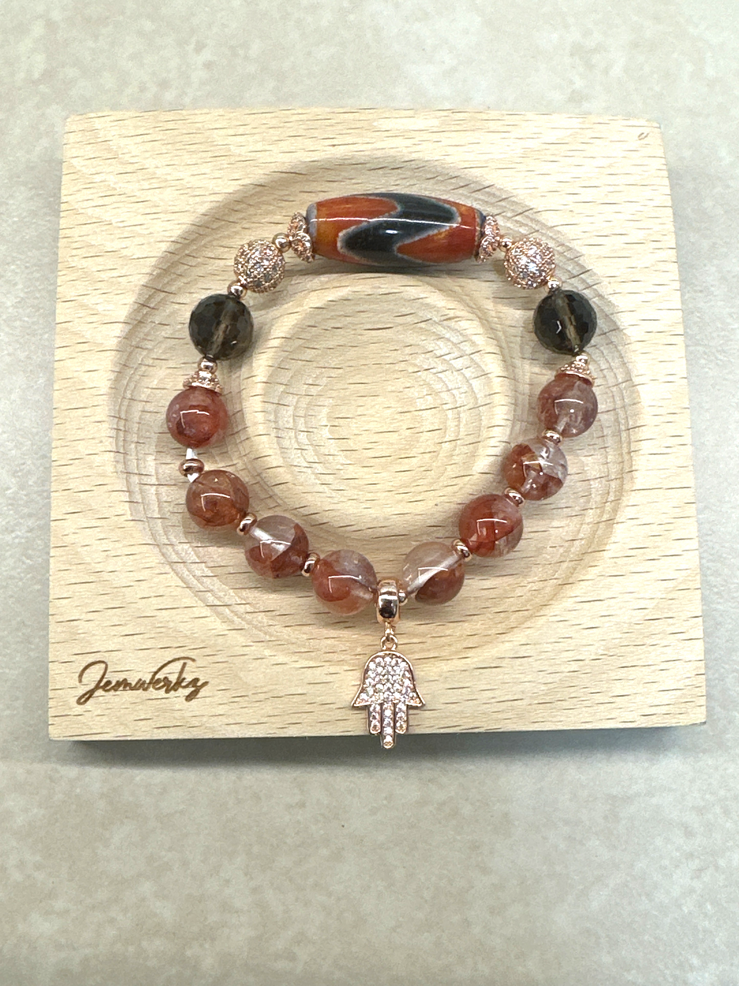 DAHLIA 1.1 - Dzi Tiger Tooth, Fire Quartz, Faceted Smoky Quartz, Hamsa Charm Bracelet