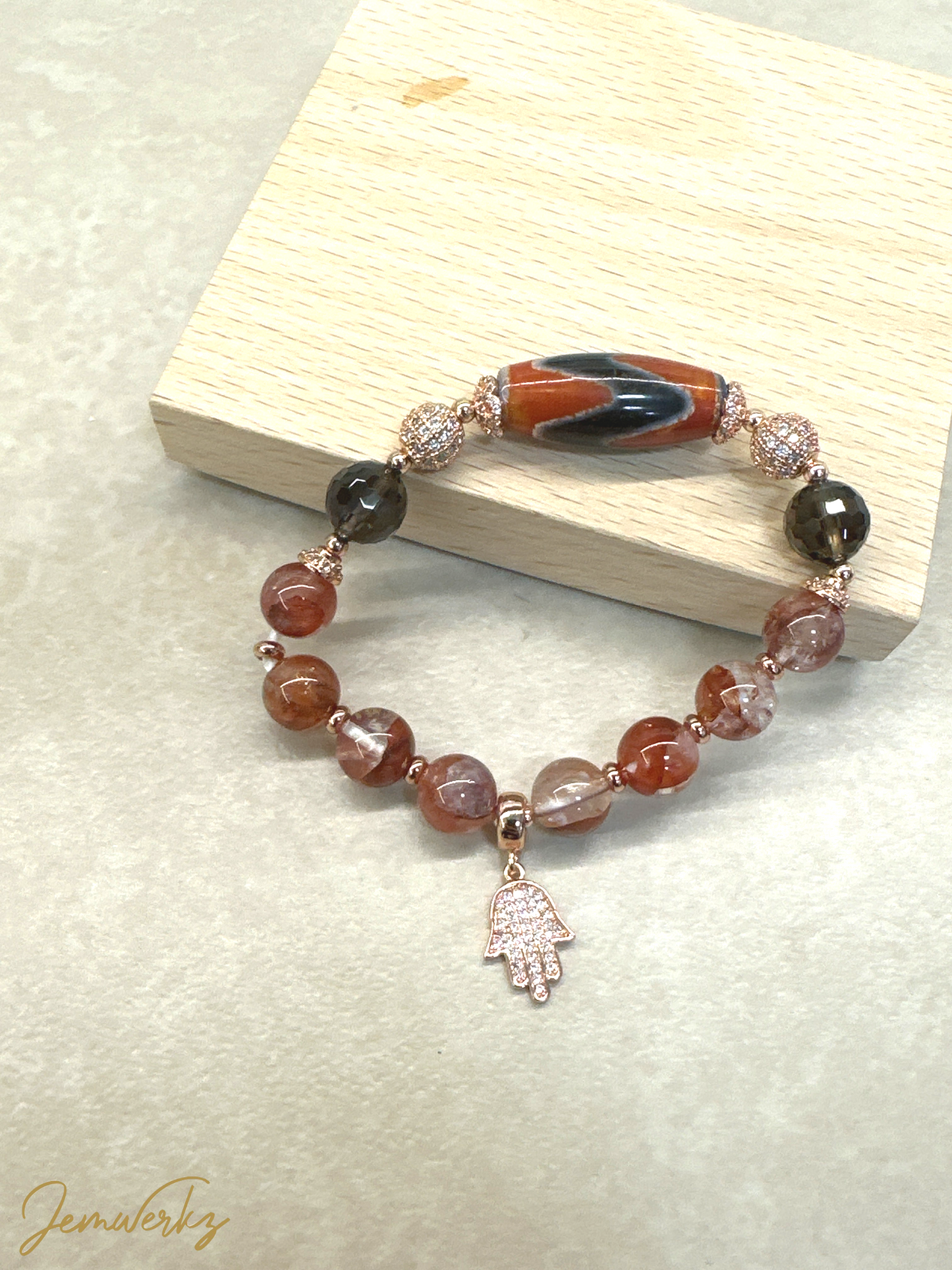 DAHLIA 1.1 - Dzi Tiger Tooth, Fire Quartz, Faceted Smoky Quartz, Hamsa Charm Bracelet